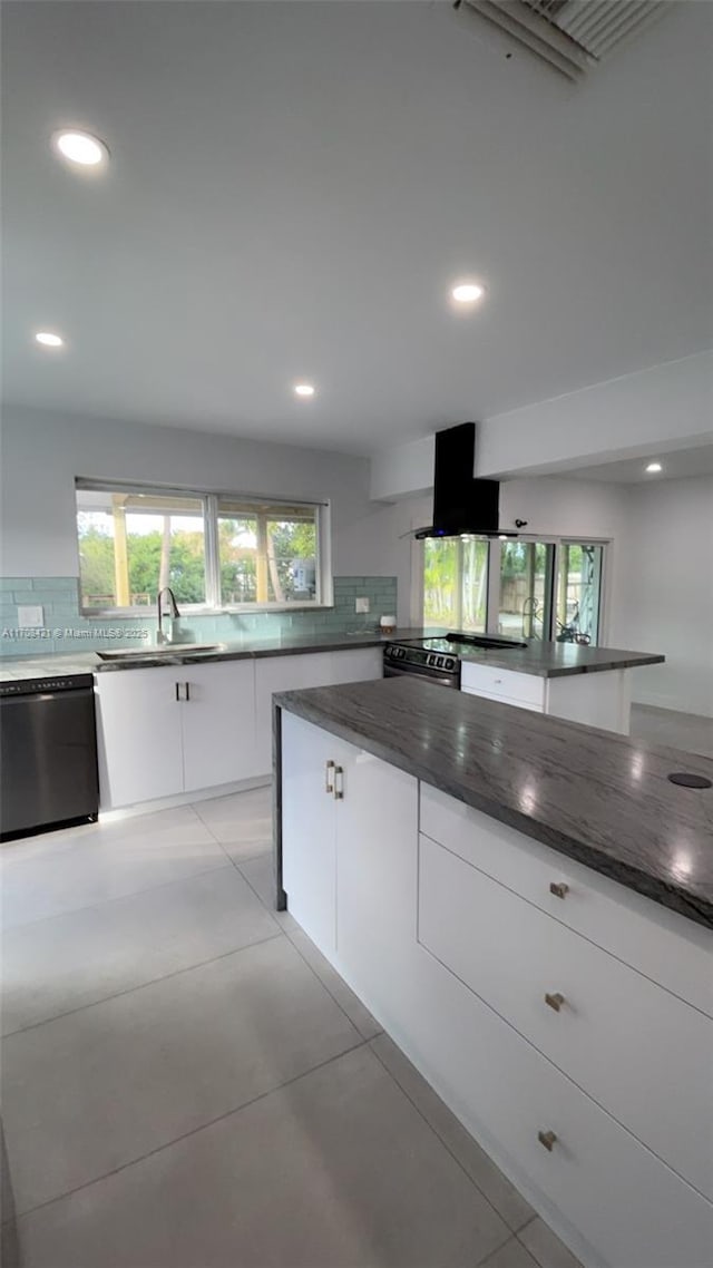 kitchen featuring tasteful backsplash, dishwasher, island exhaust hood, white cabinetry, and a sink