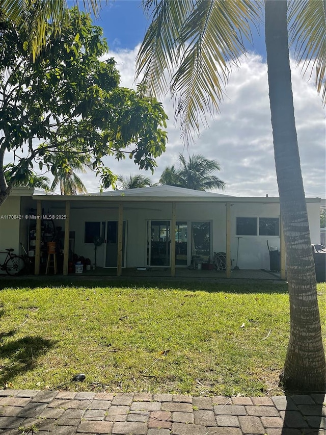 rear view of house with a yard