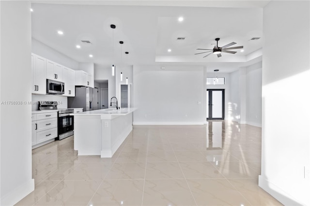 kitchen with a center island with sink, pendant lighting, white cabinetry, and stainless steel appliances