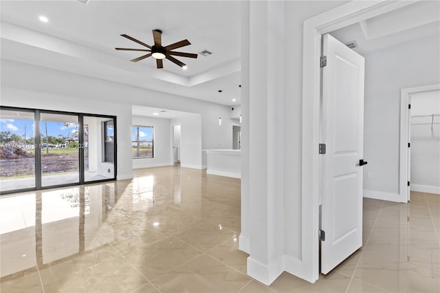 hall featuring a tray ceiling