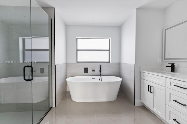 bathroom with vanity, tile walls, and plus walk in shower