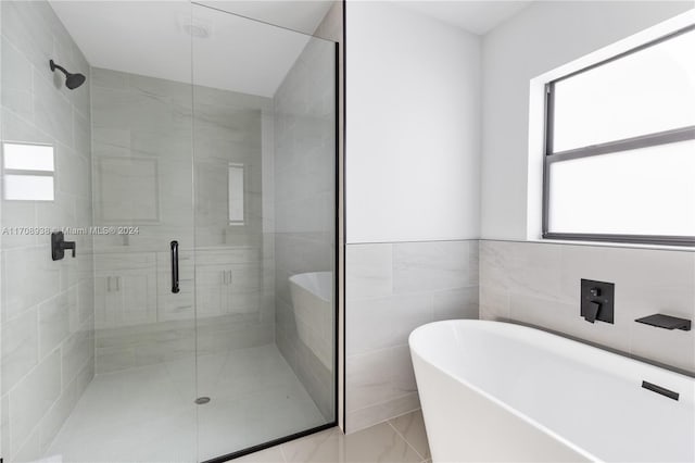 bathroom with plus walk in shower and tile walls