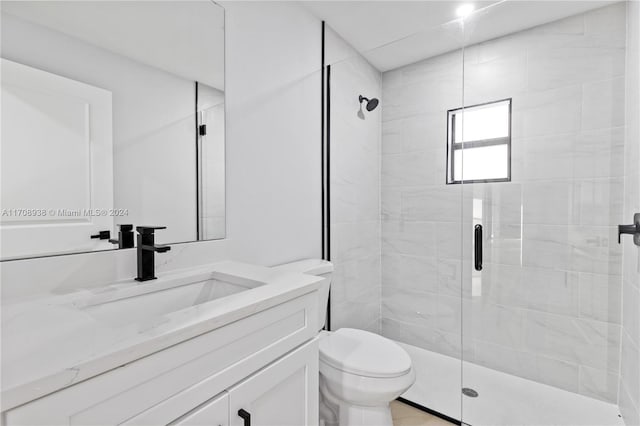 bathroom with vanity, toilet, and an enclosed shower