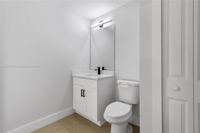 bathroom with tile patterned floors, vanity, and toilet