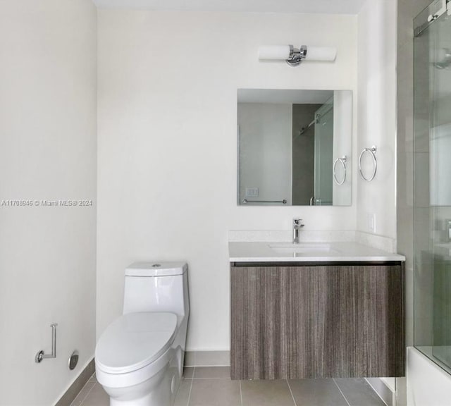 full bathroom featuring tile patterned flooring, vanity, toilet, and enclosed tub / shower combo