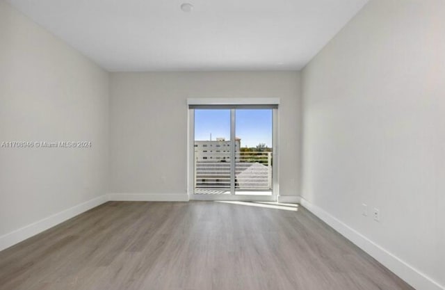 spare room with hardwood / wood-style floors