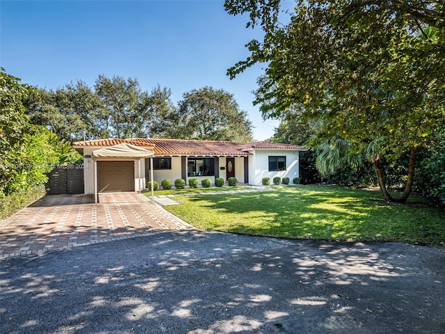 mediterranean / spanish home with a garage and a front yard