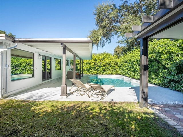 view of pool featuring a patio area and a lawn