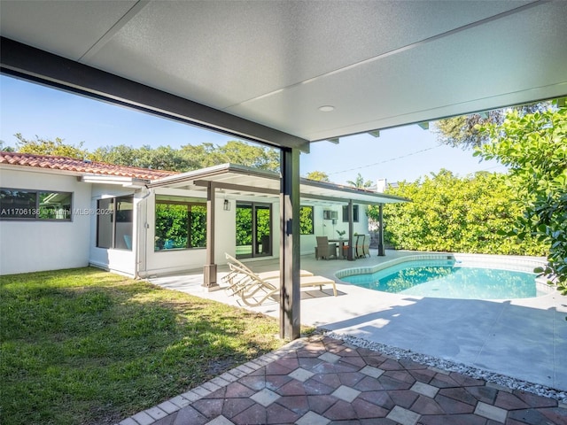 view of swimming pool with a patio area and a lawn