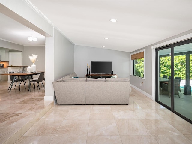 living room with crown molding and vaulted ceiling