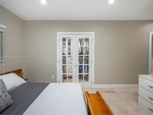 bedroom with light tile patterned floors and french doors