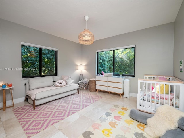 tiled bedroom with a nursery area