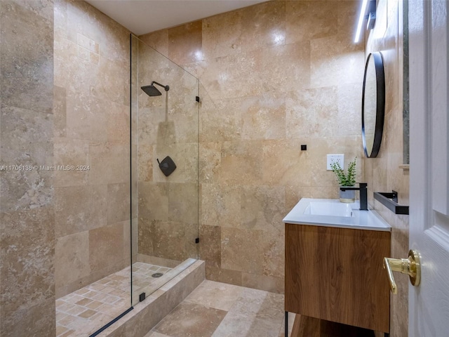 bathroom with vanity, tile walls, and tiled shower