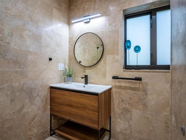 bathroom featuring vanity and tile walls