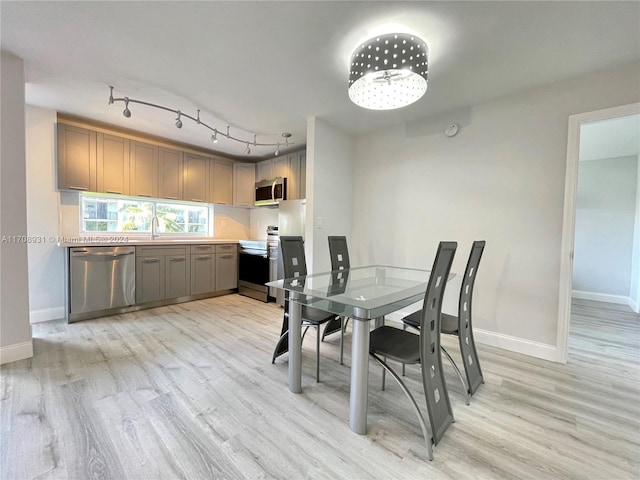 dining area featuring sink and light wood-type flooring