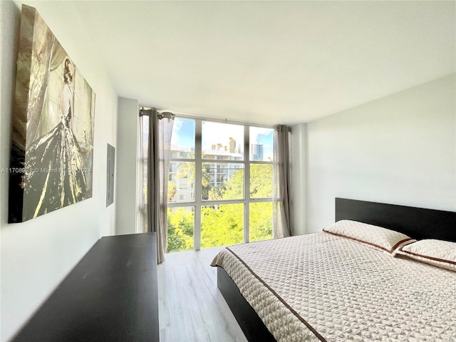 bedroom featuring hardwood / wood-style flooring and floor to ceiling windows