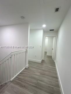 corridor featuring dark hardwood / wood-style flooring