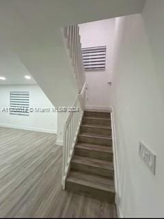 stairway with hardwood / wood-style flooring