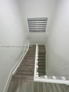 staircase featuring hardwood / wood-style floors