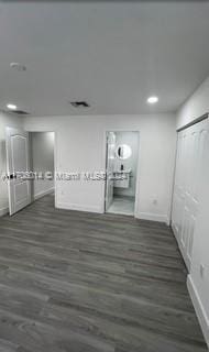 unfurnished bedroom with dark hardwood / wood-style floors