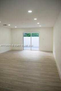 spare room with dark hardwood / wood-style flooring