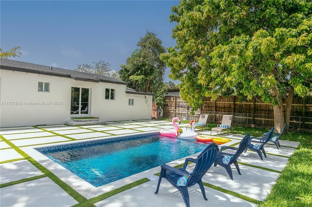 view of swimming pool with a patio area