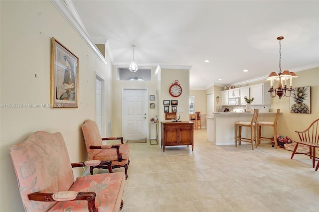 sitting room featuring ornamental molding, light tile patterned floors, and a chandelier