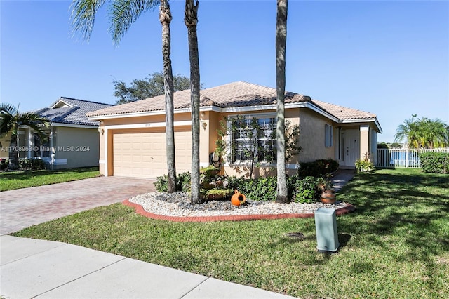 ranch-style home with a garage and a front yard