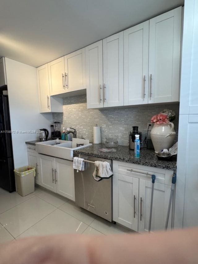 kitchen with dishwasher, sink, black fridge, backsplash, and white cabinets