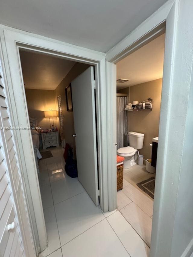 corridor with light tile patterned floors