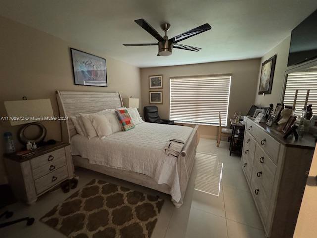 bedroom featuring ceiling fan and light tile patterned floors