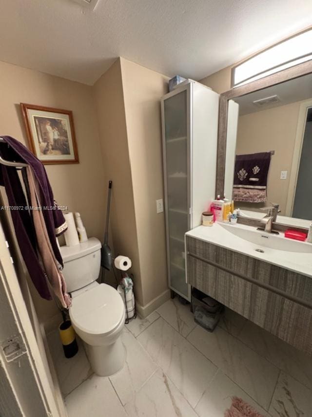 bathroom with vanity and toilet