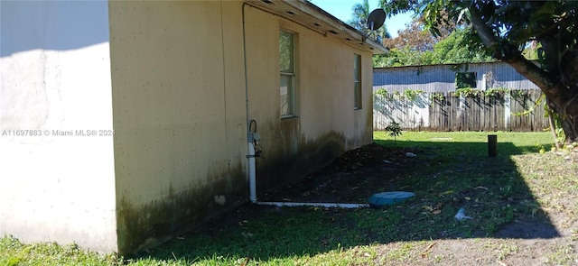 view of side of home featuring a yard