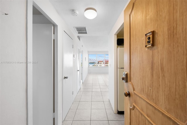 hall featuring light tile patterned floors