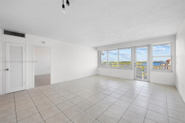 tiled empty room with a water view