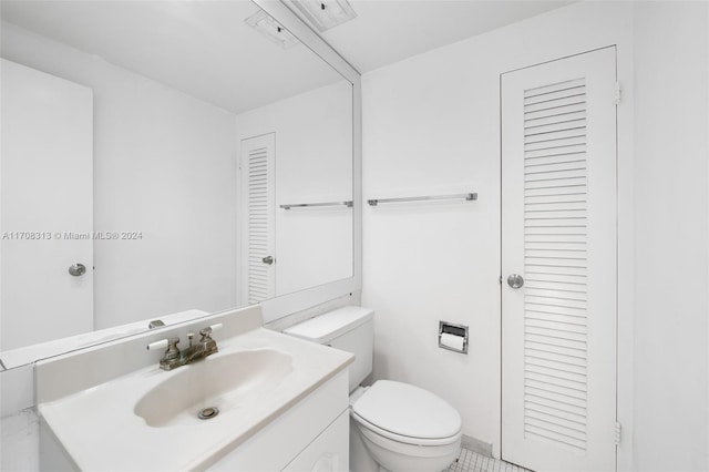 bathroom featuring tile patterned floors, vanity, and toilet