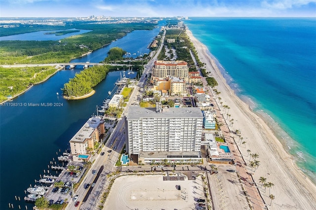 drone / aerial view with a beach view and a water view