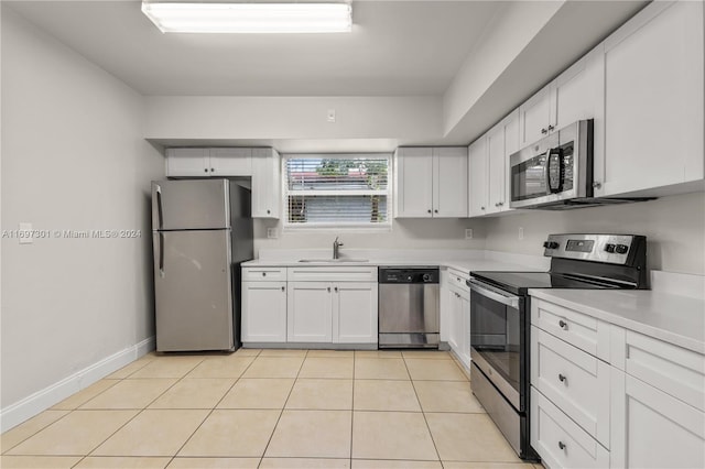 kitchen with white cabinetry, sink, light tile patterned floors, and appliances with stainless steel finishes