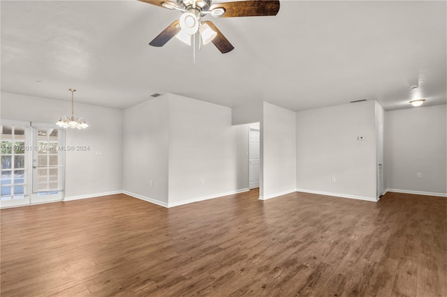 unfurnished living room featuring dark hardwood / wood-style floors and ceiling fan with notable chandelier