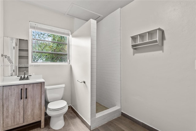 bathroom with a shower, wood-type flooring, vanity, and toilet