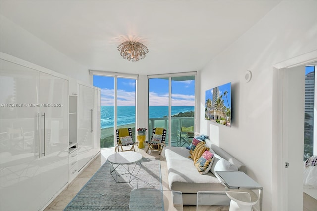 sunroom / solarium featuring a water view