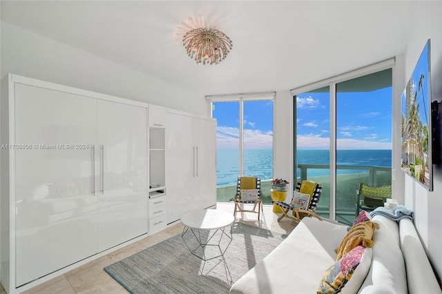 sunroom / solarium featuring a water view