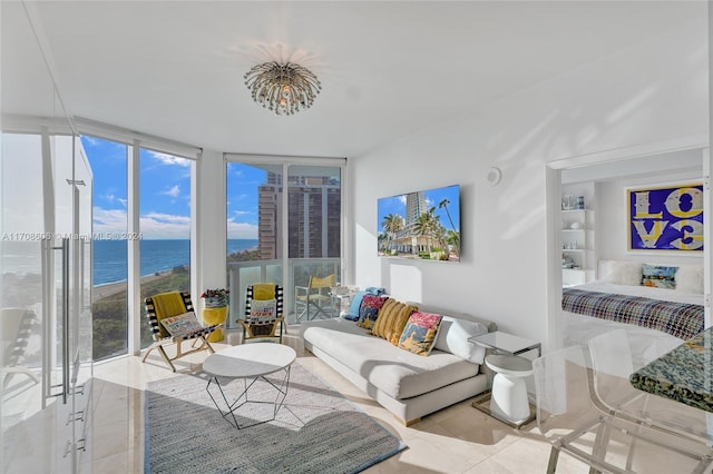 tiled living room featuring floor to ceiling windows and a water view