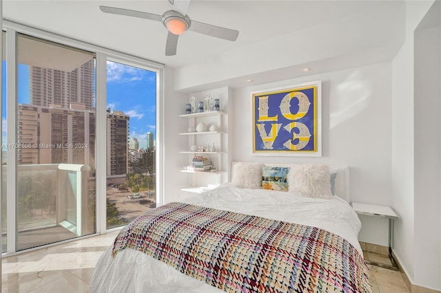 bedroom with access to exterior, expansive windows, and ceiling fan