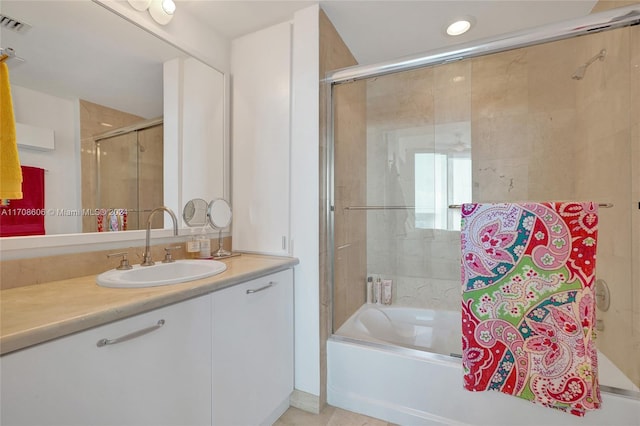 bathroom with tile patterned floors, vanity, and combined bath / shower with glass door