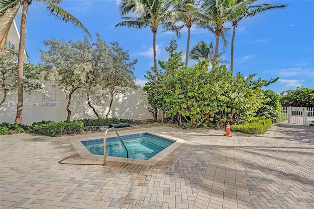 view of pool featuring an in ground hot tub