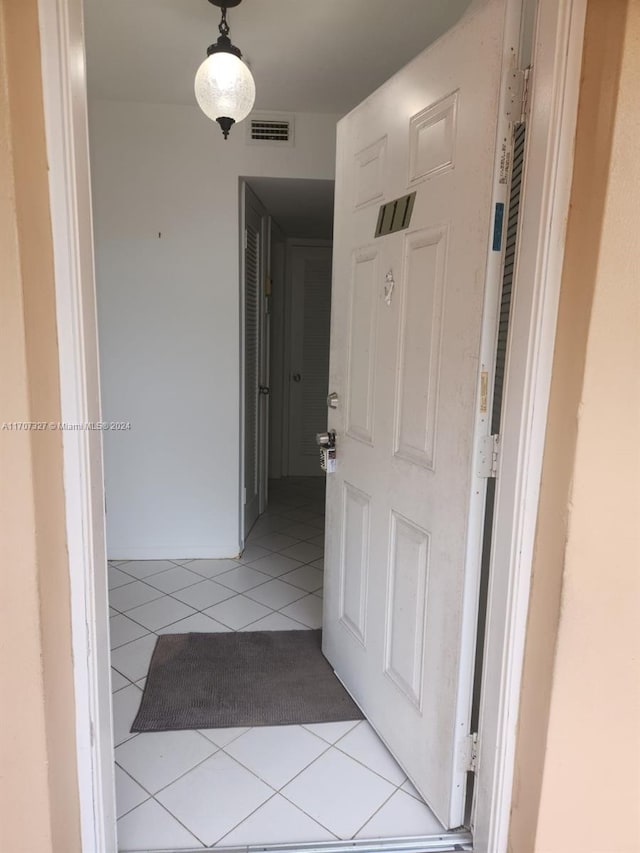 corridor featuring light tile patterned floors