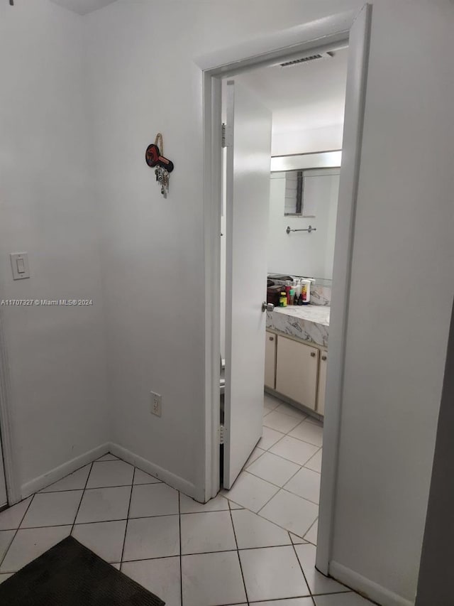 hall featuring light tile patterned flooring