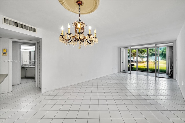unfurnished room with light tile patterned flooring, visible vents, a notable chandelier, and a wall of windows