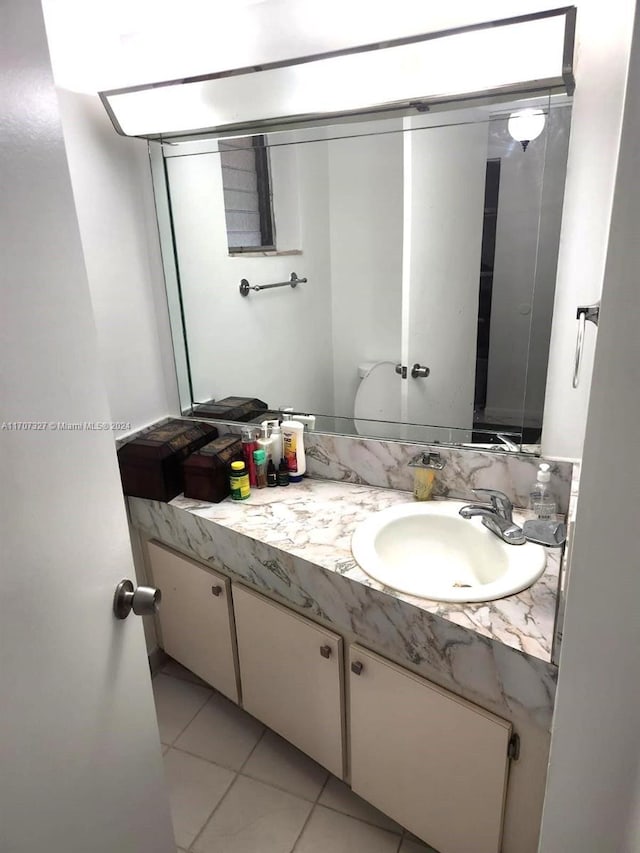 bathroom with tile patterned floors and vanity